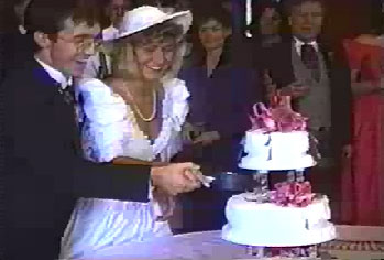groom and bride cutting a wedding cake